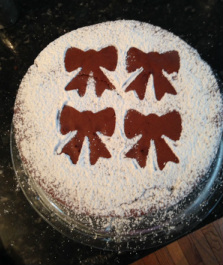Chocolate cake with powdered sugar stenciled bows