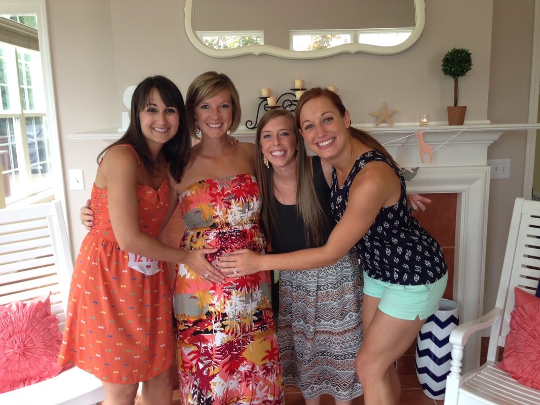 Girls posing with pregnant woman in colorful dresses